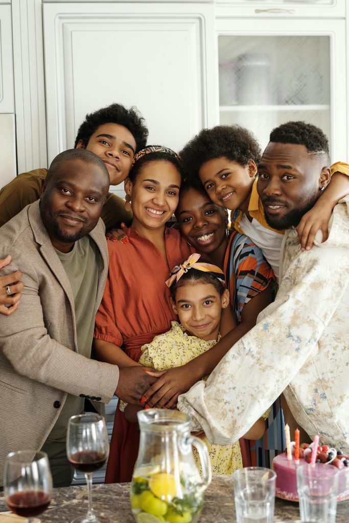 Happy family gathering in a cozy kitchen, celebrating with joy and love.